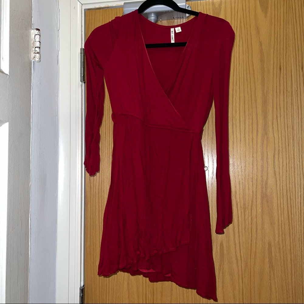 Red long sleeve faux wrap style dress.